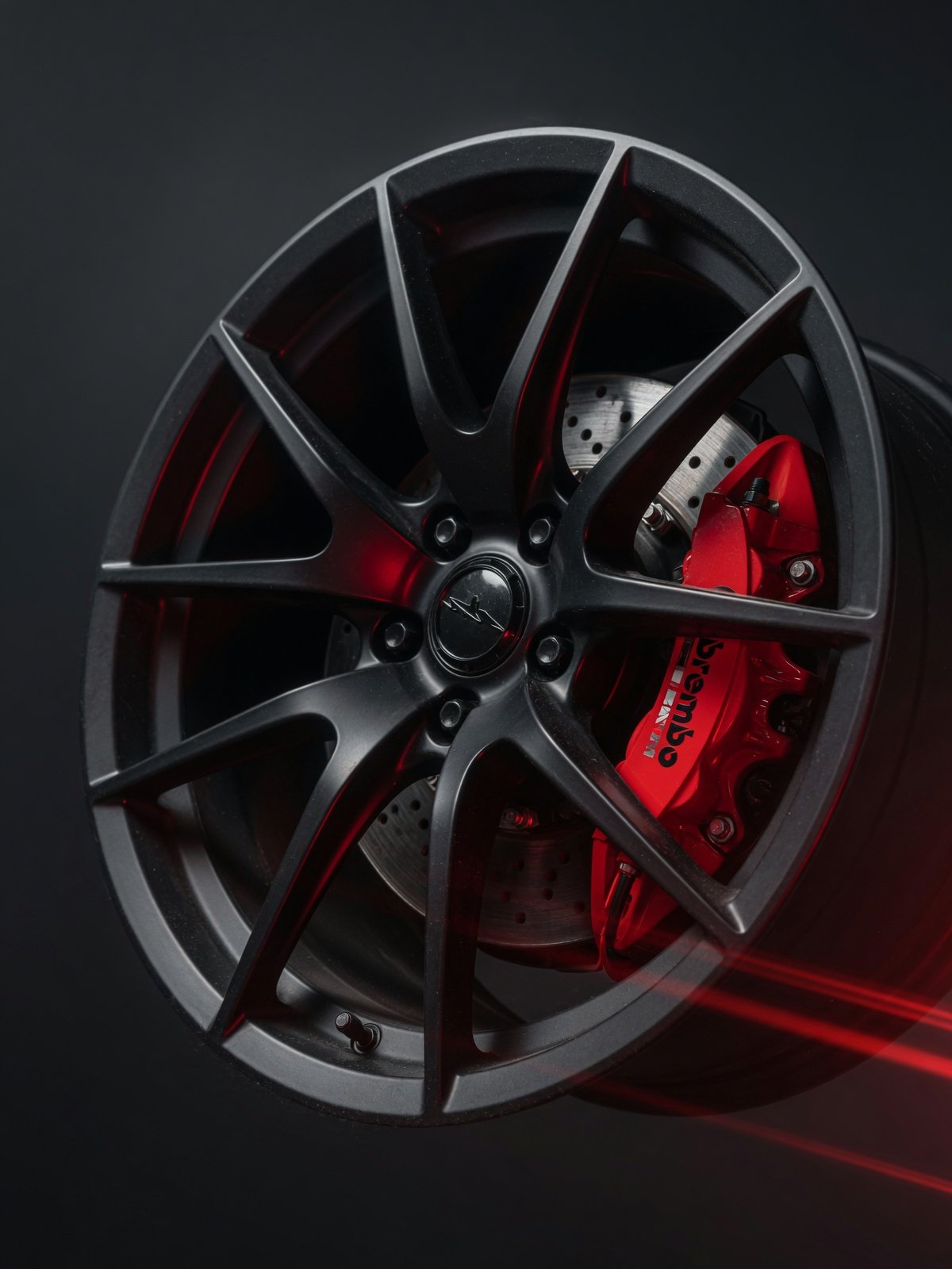 Black alloy wheel with red brake caliper